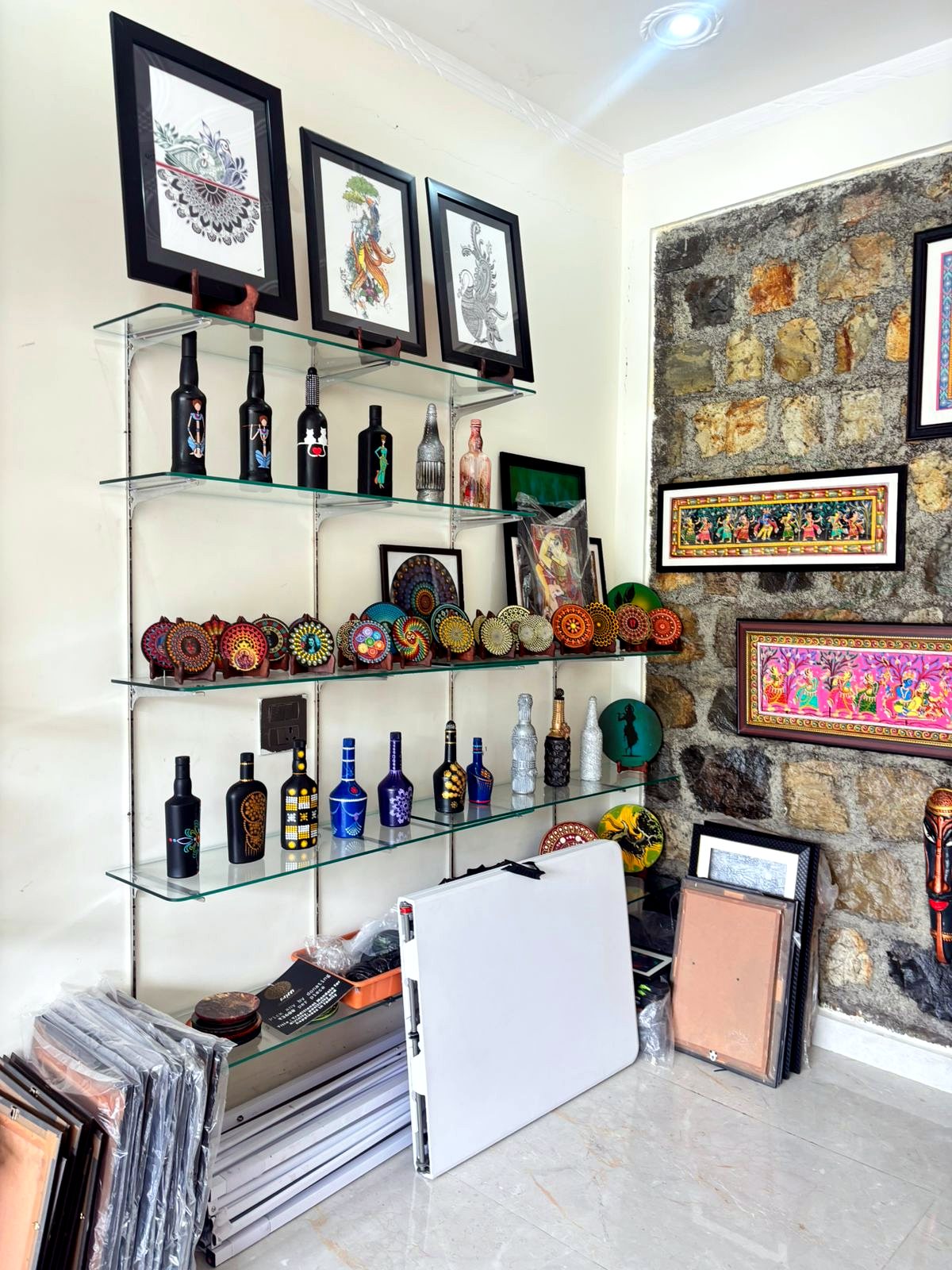 Shelves with bottles, framed art, and decorative artworks