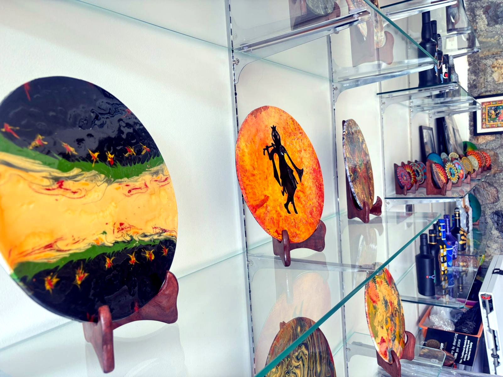 Gallery shelves with round painted artworks